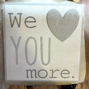 Wooden sign. WE LOVE YOU MORE